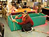 Zach Hoyt fixing cracks in the crab tank