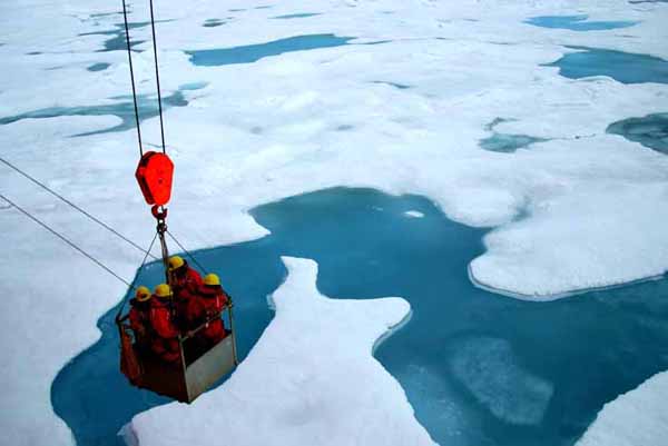 Some exploration team members are lowered onto the pack ice