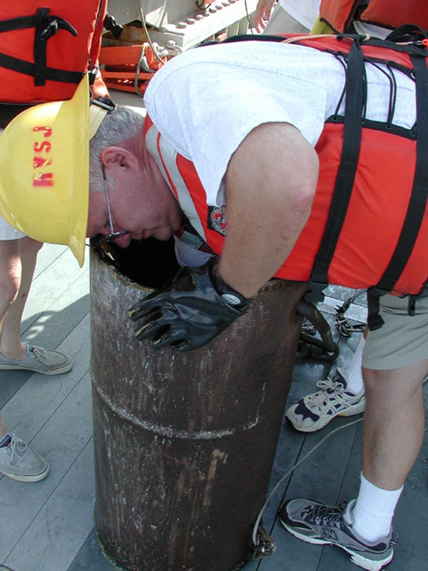 Jerry McLelland, reaches into the pipe dredge