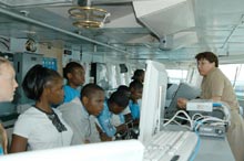 NOAA corps LTJG Jennifer Pralgo introducing students to the bridge