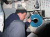 Jason Chaytor shines a flashlight out the porthole to assist Alvin pilot.