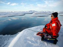 Sue Moore listening intently to real-time sounds captured by an underwater hydrophone.