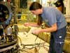 Remotely operated vehicle (ROV) pilot Bryan Schaefer uses a heat gun to repair an electrical cable in the hydraulic system.