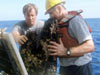 Scientist remove a huge, extinct sulfide sample from the elevator, after its trip from the seafloor to the surface.