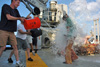 Adriana is greeted by several buckets of water immediately after exiting the sub.