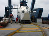 The ALVIN submersible is rolled out of its hangar and back to the ATLANTIS fantail along a special curved railroad track.