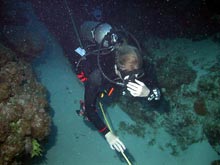 Twilight Zone technical diver Liz Kintzing lays a guide line along the wall face.