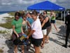 Student assistants from the University of Delaware study abroad program help carry the Gavia AUV to the beach for a launch.