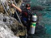 Preparing to conduct underwater video transects, sientist enter the water from a platform at Oil Slick Leap dive site.