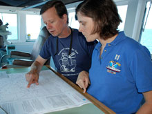 Operations Officer Lieutenant Nicole Manning confers with chief scientist Chuck Fisher about the next days dive plan.