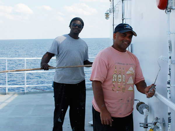 Seamen Frank Footman and Roberto Mendez (left to right) painting the deck to help keep the Ron Brown in top condition.  