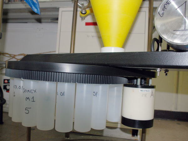 Sediment and larvae collection bottles on rotating stage at base of trap. 