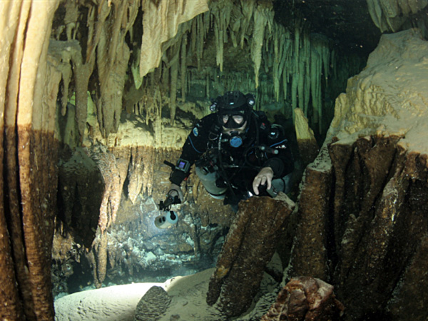 Wall rock in Green Bay Cave shows lighter colors at the ceiling and upper sections, contrasting with a dark brown iron or manganese stain below.