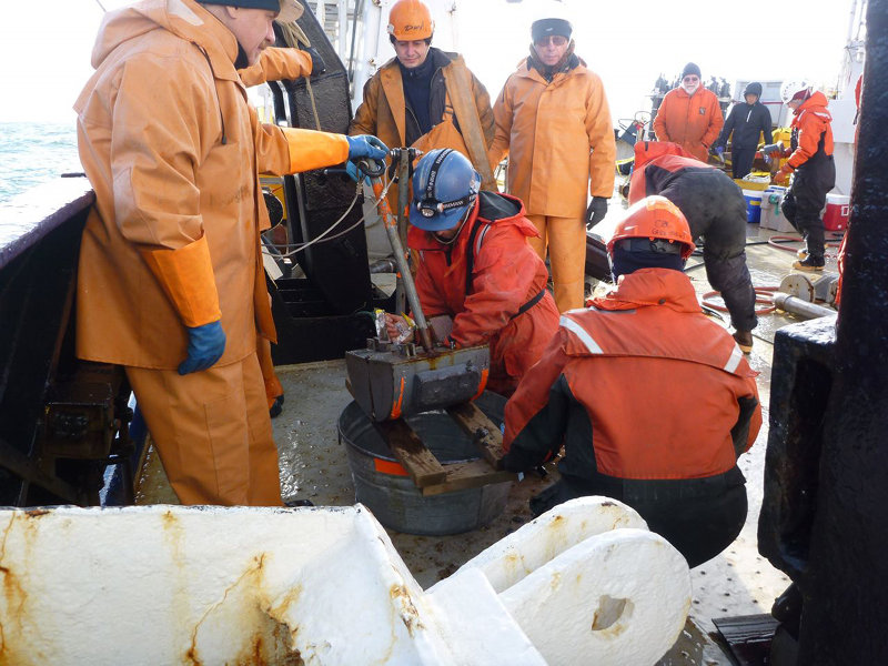 Bodhil Blum scoops a bit of sediment from a grab sample.