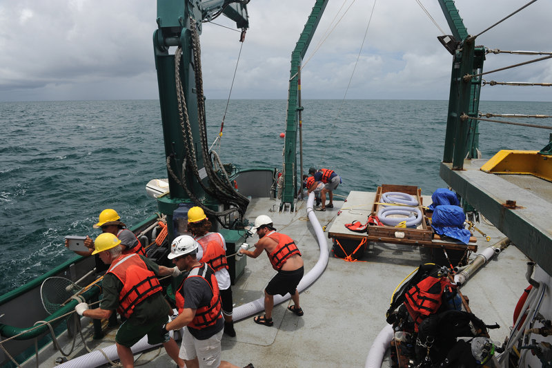 The research crew and R/V Weatherbird II crew recovering the 200 ft of 6 inch induction dredge hose.