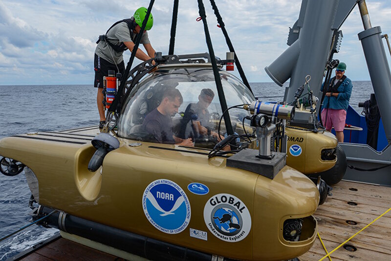 An archaeologist and pilot preparing for a dive in the Triton 1000 submersible to investigate sunken submarines from World War II. This expedition--known as the Battle of the Atlantic: Archaeology of an Underwater World War II Battlefield--featured the commission of this human-occupied vehicle capable of diving 305 meters (1,000 feet) underwater for exploration and observation.