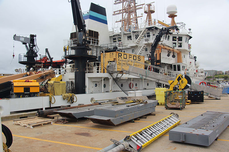 The container, containing supplies and spare parts, is secured to the deck.