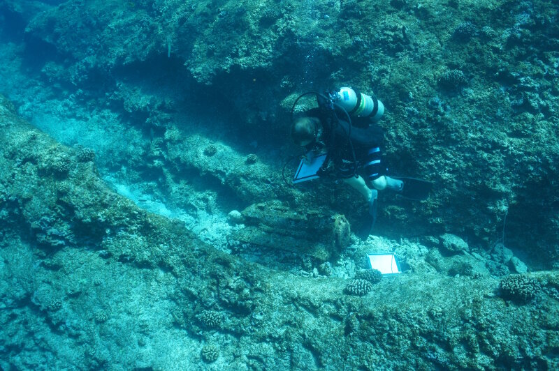 Maritime archaeologist Jason Raupp documents the engine of a P-40K Warhawk Discovered outside of the reef at Midway Atoll.