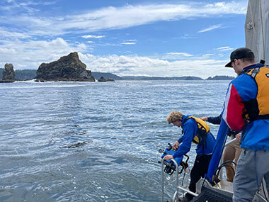 Team members from a local remotely operated vehicle (ROV) team Sea Dragons deploying their ROV from Research Vessel Storm Petrel.