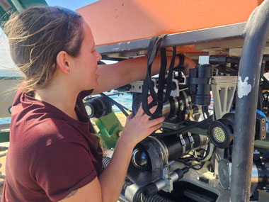 Remotely operated vehicle (ROV) crew member Samantha Flounders checks the Mohawk ROV to see if any damage occurred while at depth during Exploration of Deepwater Habitats off Puerto Rico and the U.S. Virgin Islands for Biotechnology Potential.