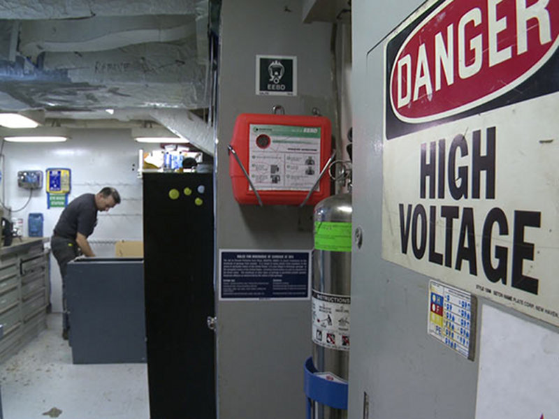 Okeanos Explorer Chief Engineer Bob Dennis considers what additional support he can provide the satellite antenna technicians to faciliate quicker and safer repairs.