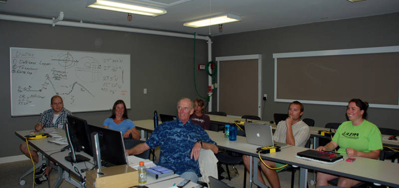 John Reed leads a group of students through a pre-dive briefing, introducing them to the scientific priorities and the potential species that we may encounter during the upcoming dives.