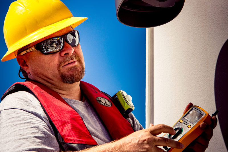 Video engineer Roland Brian works to troubleshoot some of the ship’s video equipment.