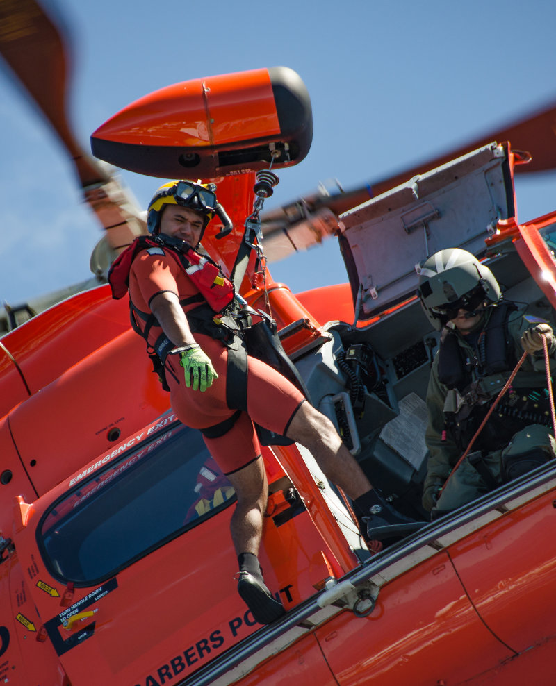 A U.S. Coast Guard rescue swimmer prepares to deploy to the bow of NOAA Ship Okeanos Explorer during a training drill off the coast of Oahu, Hawaii. Image courtesy of Deep-Sea Symphony: Exploring the Musicians Seamounts expedition, Caitlin Bailey.