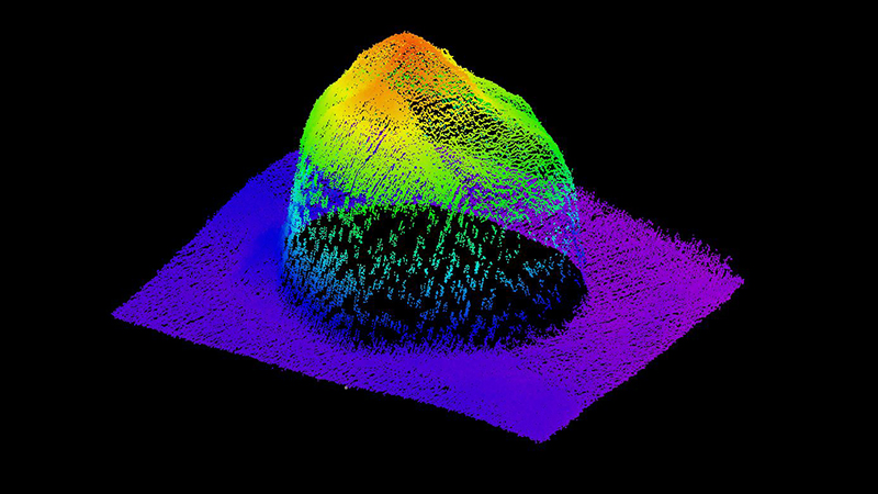 A colorful 3D plot of a mountain-like structure on a black background with a gradient spectrum from red at the peak to purple at the base.