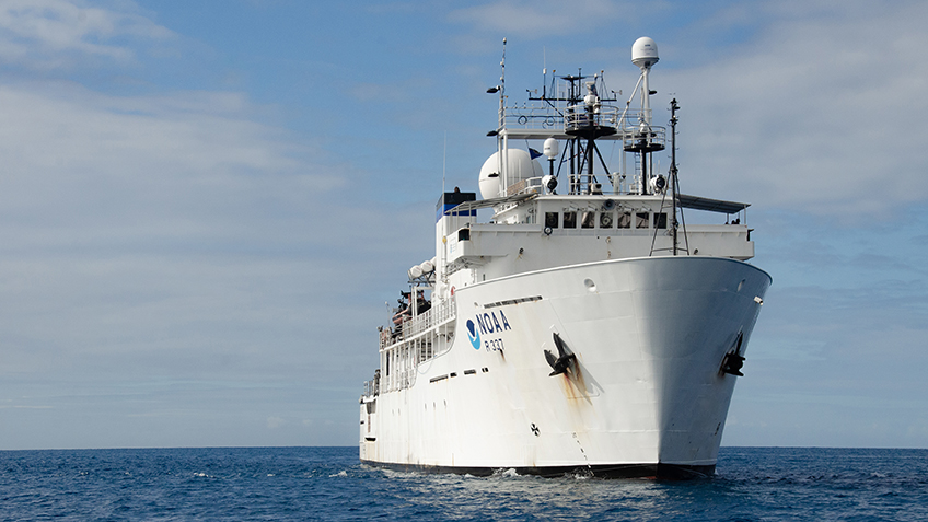 A large white research vessel on the ocean.